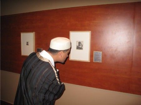 schwartz21 A visitor inspecting the cover image for the show, Rembrandt's self-portrait as an Oriental ruler.