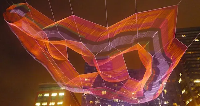 A full view (at night) of Janet Echelman’s aerial sculpture “As If It Were Already Here.” Photo: Mark Favermann.