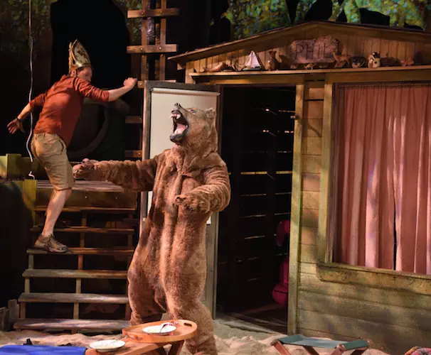Stephen Thorne as Theo and a surprise actor in a bear costume in Deborah Salem Smith’s Faithful Cheaters directed by Melia Bensussen at Trinity Rep.  Set design by Cristina Todesco, lighting design by Daniel J. Kotlowitz, costume design by Olivera Gajic. Photo Mark Turek.